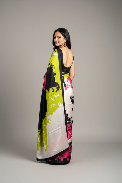 Woman wearing a colorful saree with a gradient design on a plain background