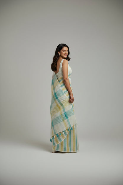 Woman wearing a striped saree on a plain background