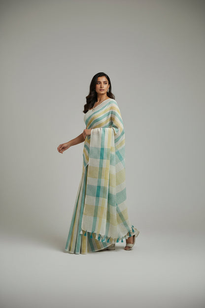 Woman wearing a striped saree on a plain background