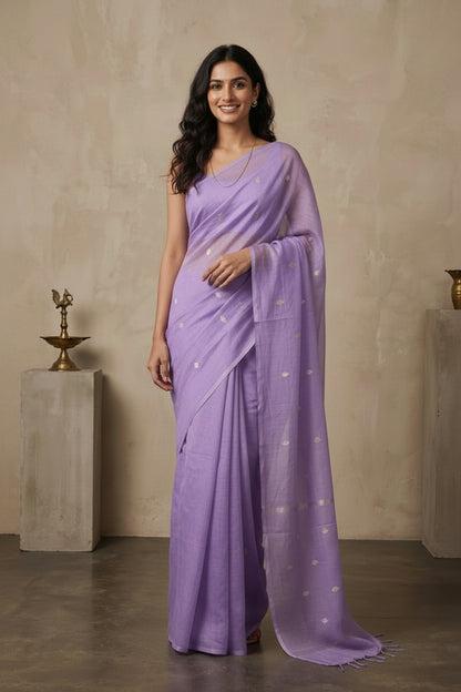 Woman wearing a lavender saree with a plain background